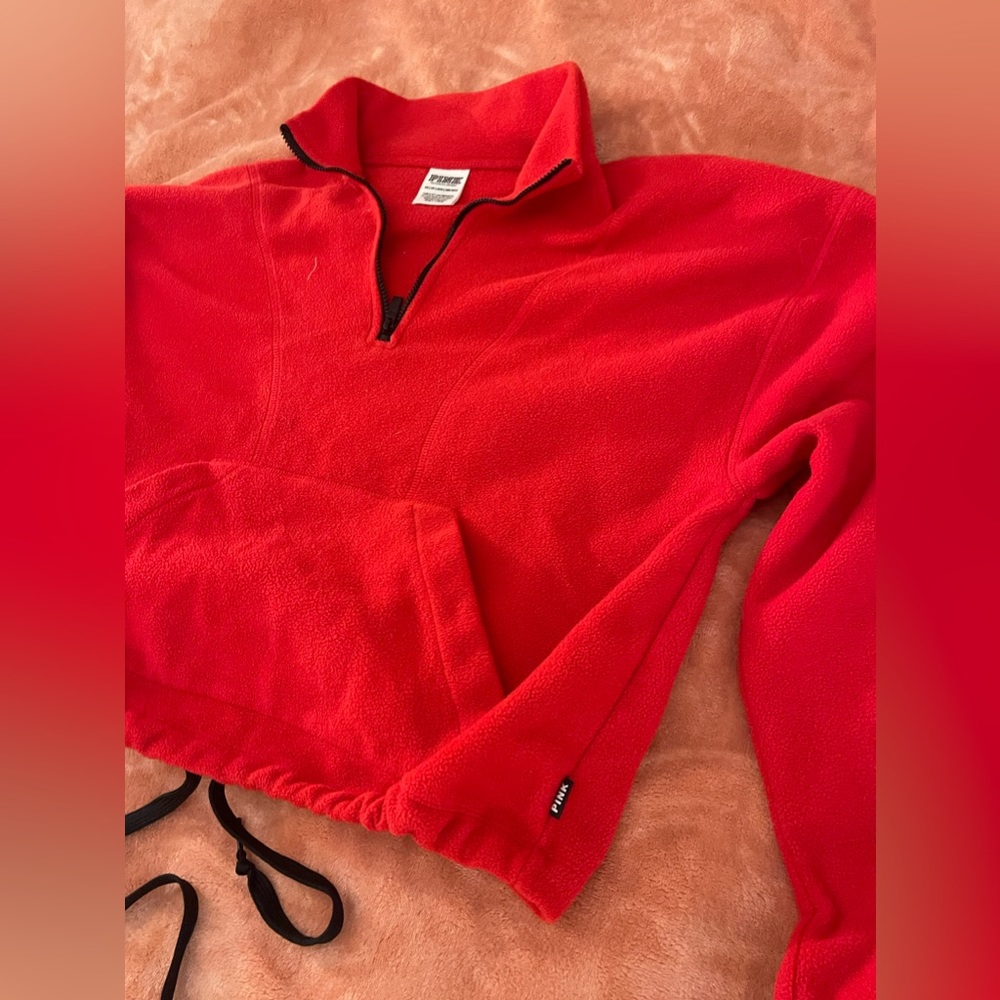 Pink crop top red sweater has ties at the bottom so you can make smaller size xs
